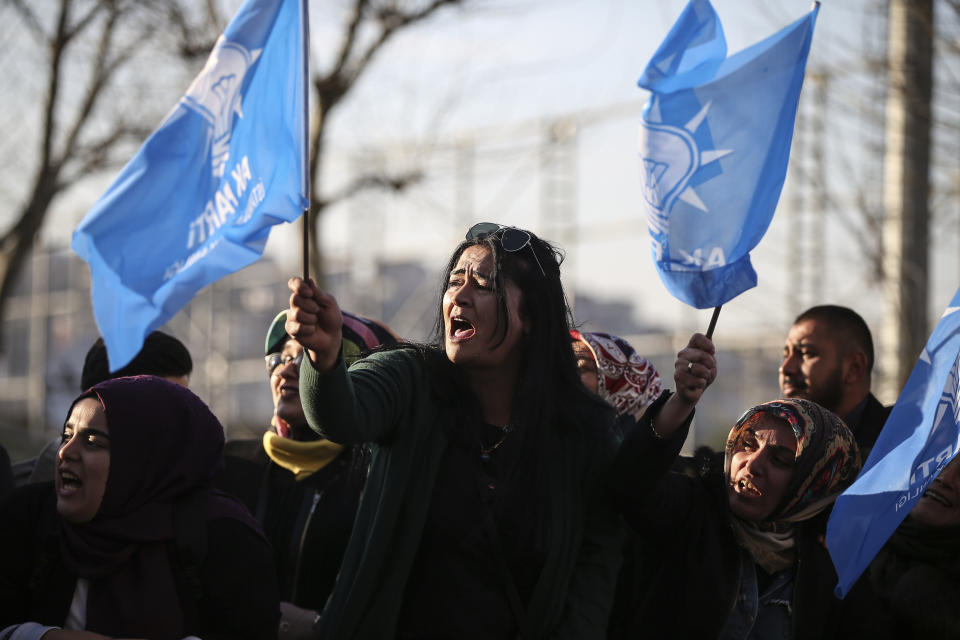 Supporters of Turkey's President Recep Tayyip Erdogan's ruling Justice and Development Party (AKP) wave party flags outside the party's headquarters a day after the local elections in Istanbul, Monday, April 1, 2019. Turkey's opposition dealt Erdogan a symbolic blow by gaining ground in key cities in the country's local elections. The opposition won the capital, Ankara, a ruling party stronghold for decades, and was leading a tight race for mayor in Istanbul, according to unofficial figures Monday. (AP Photo/Emrah Gurel)