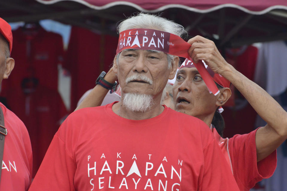 Supporters of Malaysian opposition leader Anwar Ibrahim wear Pakatan Harapan (Alliance of Hope) coalition headbands to cheer for him outside a nomination center for the upcoming general election in Tambun, Malaysia, Saturday, Nov. 5, 2022. Campaigning for Malaysia’s general elections formally started Saturday, in a highly competitive race that will see the world’s longest-serving coalition seeking to regain its dominance four years after a shocking electoral loss. (AP Photo/JohnShen Lee)