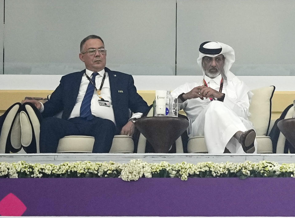 Moroccan FA President Fouzi Lekjaa, left, sits in the tribune for the World Cup semifinal soccer match between France and Morocco at the Al Bayt Stadium in Al Khor, Qatar, Wednesday, Dec. 14, 2022.(AP Photo/Martin Meissner)