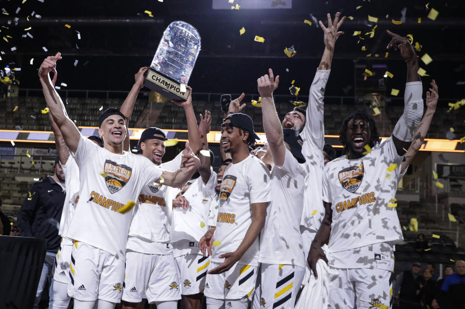 Northern Kentucky celebrates with the trophy after a 71-62 win over Illinois-Chicago in an NCAA college basketball game for the Horizon League men's tournament championship in Indianapolis, Tuesday, March 10, 2020. (AP Photo/Michael Conroy)