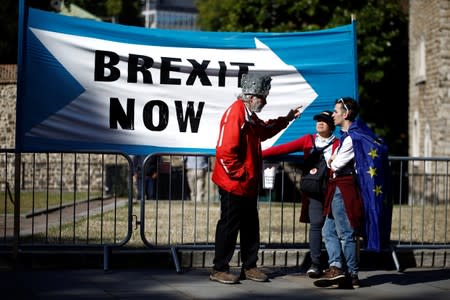 A Pro-Brexit protester talks with anti-Brexit protesters in London