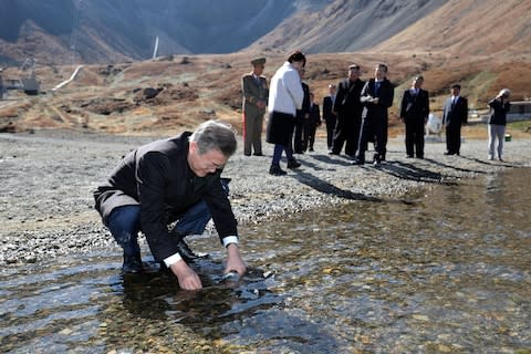 South Korean President Moon Jae-in collects water from heaven lake at the bottom of Mount Paektu during a visit with his North Korean counterpart Kim Jong-un on September 20, 2018 in Mount Paektu, North Korea - Credit:  Getty Images AsiaPac