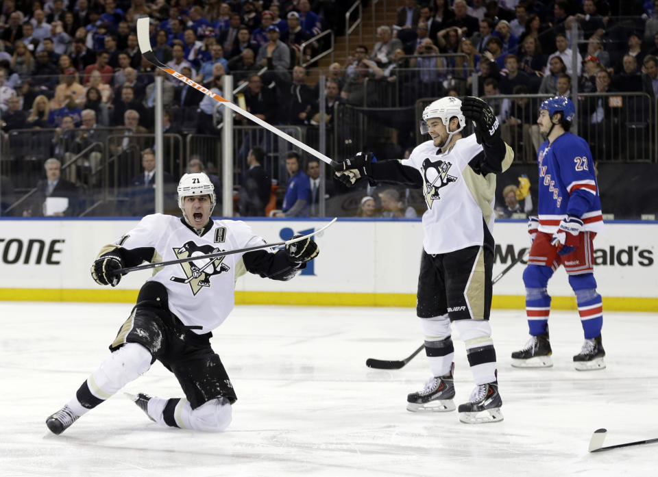 Pittsburgh Penguins' Evgeni Malkin (71), of Russia, celebrates a goal as Chris Kunitz and New York Rangers' Brian Boyle, right, skate near during the first period of a second-round NHL Stanley Cup hockey playoff series Wednesday, May 7, 2014, in New York. (AP Photo/Frank Franklin II)