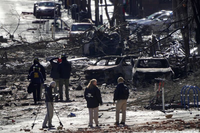 Investigators work near the site of an explosion on 2nd Avenue that occurred the day before in Nashville