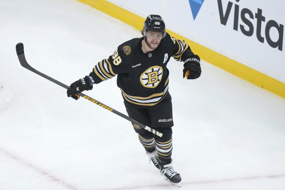 Boston Bruins right wing David Pastrnak (88) celebrates after scoring in the first period of an NHL hockey game against the Pittsburgh Penguins, Thursday, Jan. 4, 2024, in Boston. (AP Photo/Steven Senne)