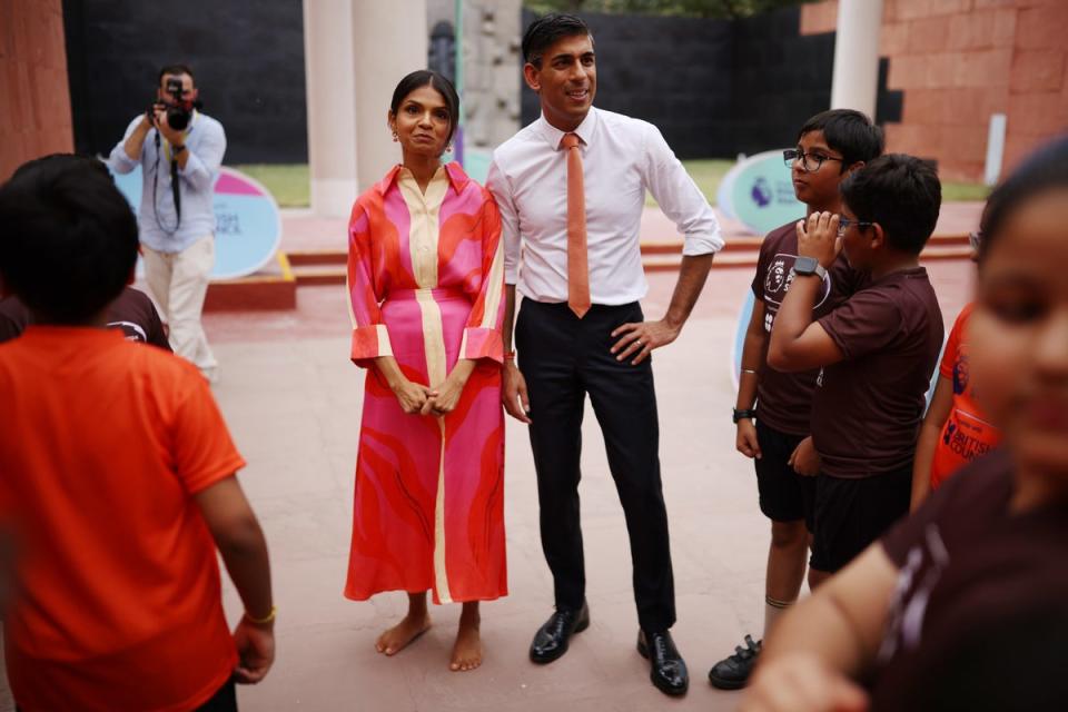 Akshata Murty in a dress by Drawn, alongside Rishi Sunak (PA Wire)