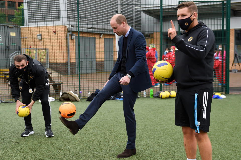 The Duke of Cambridge kicks a football during a visit to The Way Youth Zone in Wolverhampton, West Midlands. Picture date: Thursday May 13, 2021.