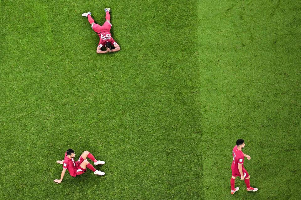 Qatar players react after they concede their third goal during the Qatar 2022 World Cup Group A football match between Qatar and Senegal at the Al-Thumama Stadium in Doha on November 25, 2022. (Photo by Kirill KUDRYAVTSEV / AFP) (Photo by KIRILL KUDRYAVTSEV/AFP via Getty Images)