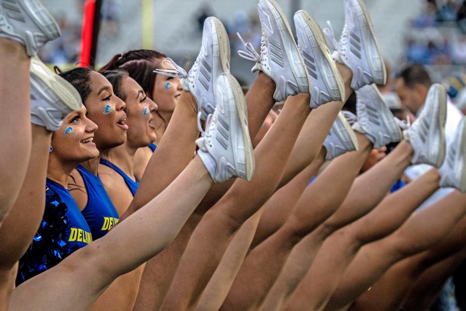 The Delaware Blue Hens cheerleaders throw a high kick during the homecoming football game against the Morgan State Bears at Delaware Stadium, Saturday, Oct. 22, 2022. Delaware 38-7. BENJAMIN CHAMBERS/DELAWARE NEWS JOURNAL