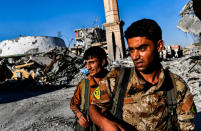 <p>Members of the Syrian Democratic Forces (SDF), backed by US special forces, check the area near Raqa’s stadium as they clear the last positions on the frontline on Oct. 16, 2017 in the Islamic State (IS) group jihadists crumbling stronghold. (Photo: Bulent Kilic/AFP/Getty Images) </p>