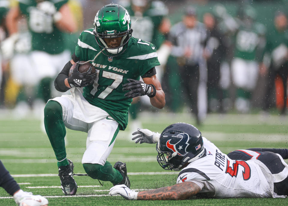 Dec 10, 2023; East Rutherford, New Jersey, USA; New York Jets wide receiver Garrett Wilson (17) fights for yards as Houston Texans safety <a class="link " href="https://sports.yahoo.com/nfl/players/33992" data-i13n="sec:content-canvas;subsec:anchor_text;elm:context_link" data-ylk="slk:Jalen Pitre;sec:content-canvas;subsec:anchor_text;elm:context_link;itc:0">Jalen Pitre</a> (5) pursues during the second half at MetLife Stadium. Mandatory Credit: Vincent Carchietta-USA TODAY Sports
