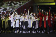 Members of Team France arrives during the opening ceremony in the Olympic Stadium at the 2020 Summer Olympics, Friday, July 23, 2021, in Tokyo, Japan. (Hannah McKay/Pool Photo via AP)