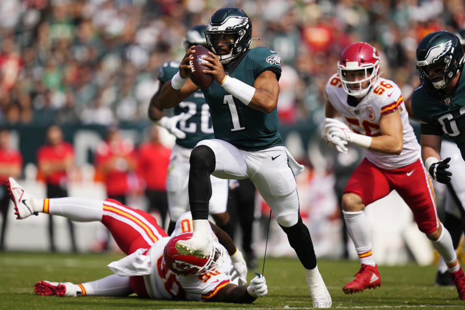 FILE - Philadelphia Eagles quarterback Jalen Hurts (1) runs with the ball as Kansas City Chiefs defensive tackle Jarran Reed (90) holds onto part of Hurts' uniform during the first half of an NFL football game in Philadelphia, in this Sunday, Oct. 3, 2021, file photo. The Kansas City Chiefs and Washington head into their matchup this weekend as two of the worst defenses in the NFL. No teams have allowed more points this season and they're both coming off allowing 30-plus points last week. (AP Photo/Matt Slocum, File)