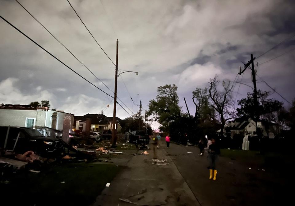 People view damage to buildings in the Arabi neighborhood after a large tornado struck New Orleans on Tuesday (REUTERS)