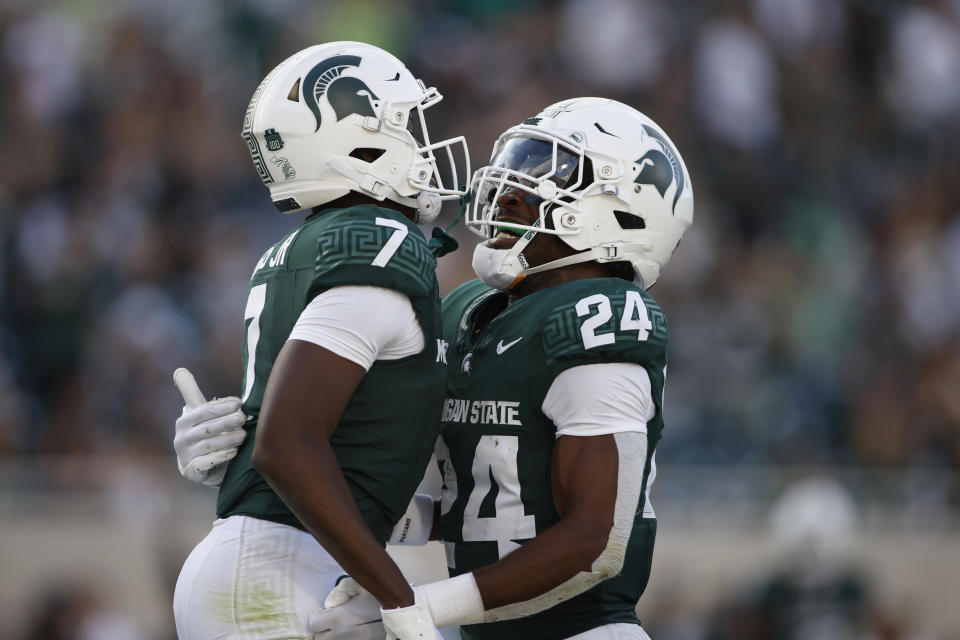 Michigan State's Antonio Gates Jr., left, celebrates with Davion Primm (24) after his touchdown reception against Richmond during the second half of an NCAA college football game, Saturday, Sept. 9, 2023, in East Lansing, Mich. Michigan State won 45-14. (AP Photo/Al Goldis)