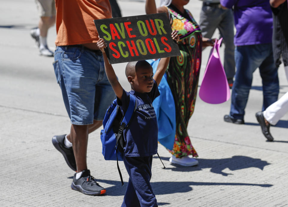 <p>A young activists holds a sign as he march onto Chicago Dan Ryan Expressway to protest violence in the city on July 7, 2018 in Chicago, Ill. (Photo: Kamil Krzaczynski/Getty Images) </p>