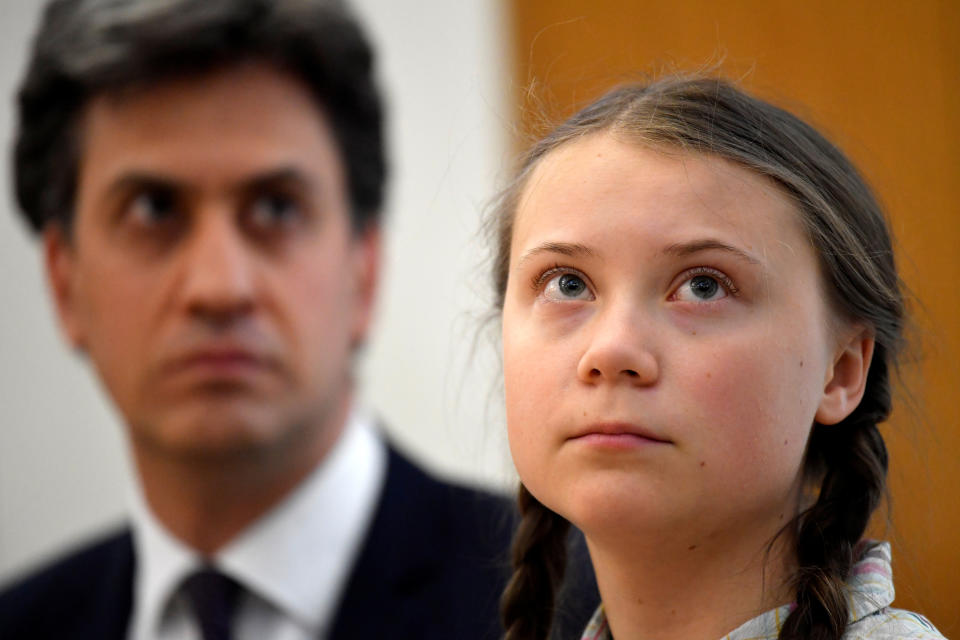 Swedish environmental activist Greta Thunberg looks on next to the former leader of Britain's opposition Labour Party Ed Miliband at the House of Commons as guest of Caroline Lucas, in London, Britain April 23, 2019. REUTERS/Toby Melville