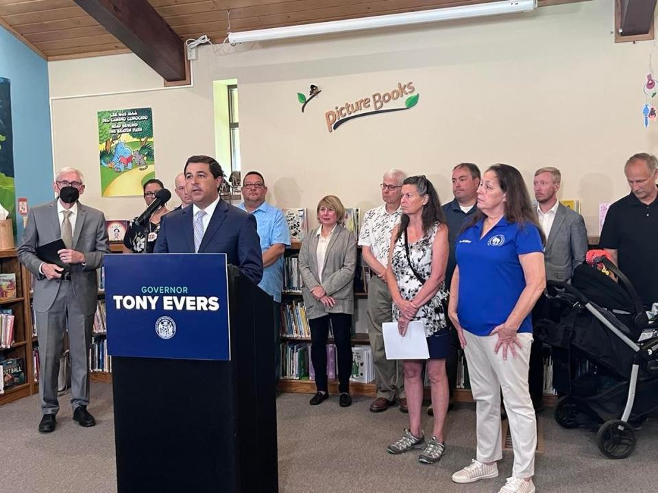 Attorney General Josh Kaul, center, and Gov. Tony Evers, far left, announce a lawsuit against manufacturers of PFAS chemicals at a news conference July 20 in the Town of Campbell outside of La Crosse.