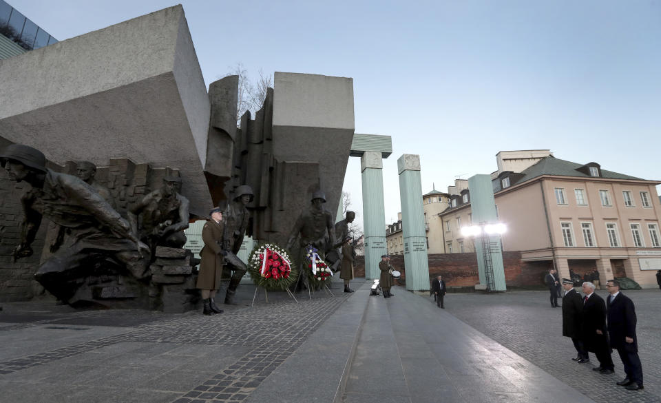 United States Vice President Mike Pence, 2nd right, and Poland's Prime Minister Mateusz Morawiecki, right, attend a wreath-laying ceremony at the 'Warsaw Uprising Monument' in Warsaw, Poland, Thursday, Feb. 14, 2019. The Polish capital is host for a two-day international conference on the Middle East, co-organized by Poland and the United States. (AP Photo/Michael Sohn)