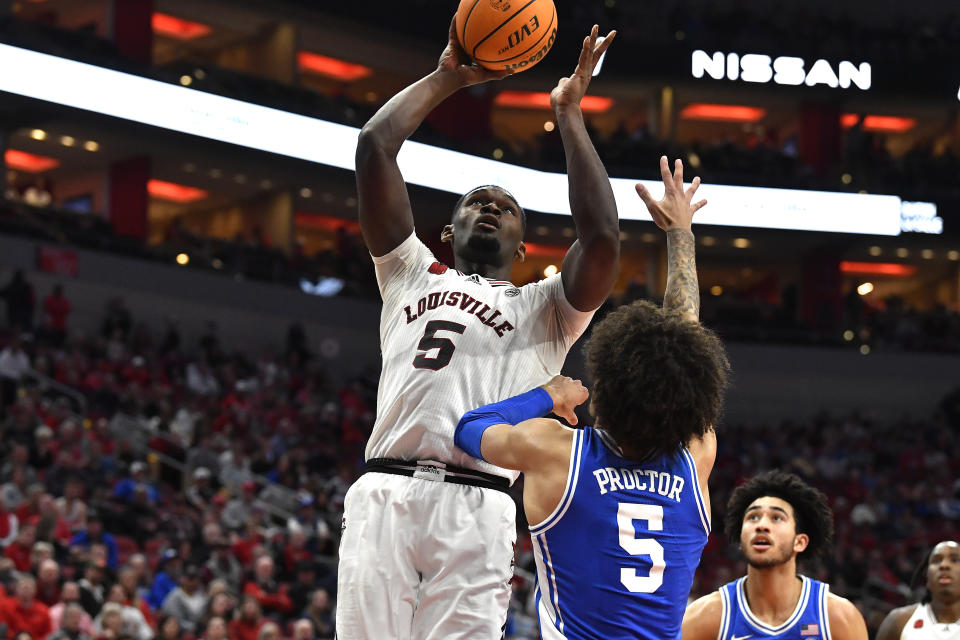 Louisville forward Brandon Huntley-Hatfield (5) shoots over Duke guard Tyrese Proctor (5) during the second half of an NCAA college basketball game in Louisville, Ky., Tuesday, Jan. 23, 2024. Duke won 83-69. (AP Photo/Timothy D. Easley)