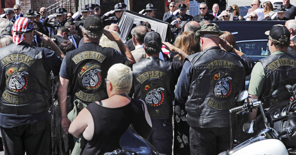 Members of the Jarheads Motorcycle Club and a police honor guard salute as the casket of Michael Ferazzi arrives at St. Peter's Catholic Church in Plymouth, Mass., Friday, June 28, 2019. Ferazzi, a motorcyclist and retired police officer, was killed in a fiery crash that claimed the lives of seven people riding with the Jarheads Motorcycle Club in New Hampshire. (AP Photo/Charles Krupa)