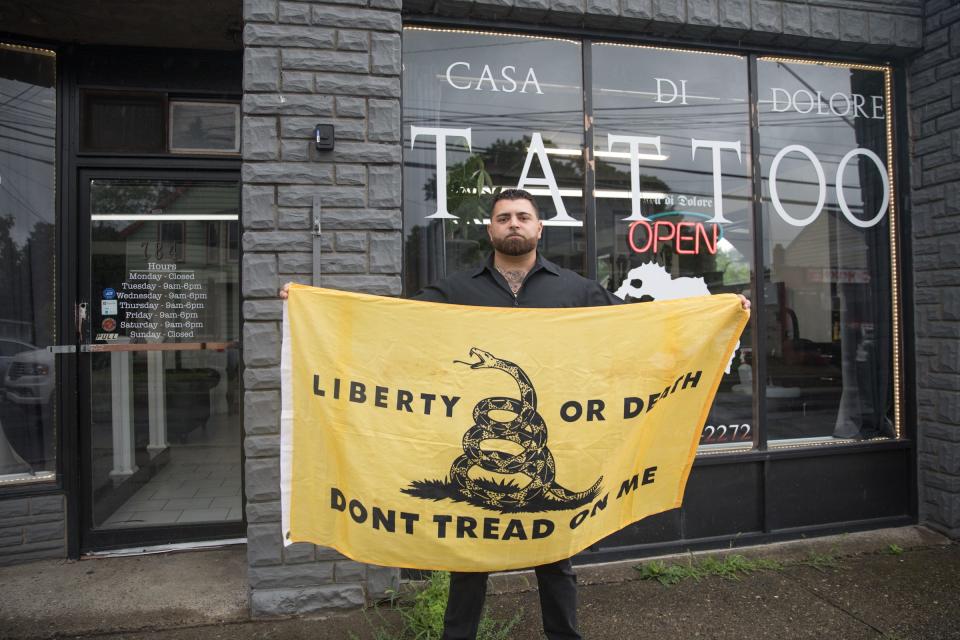 In this file photo, Roberto Minuta displays his opposition to the NY law that removed religious exemption to measles vaccinations for children entering public schools, outside his business  Casa Di Dolore in Newburgh, on June 21, 2019.