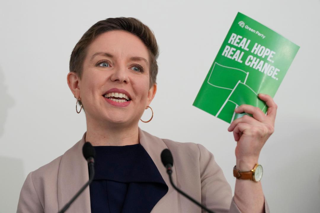 Green Party co-leader Carla Denyer holds up a manifesto as she speaks at their General Election Manifesto launch - Real Hope, Real Change, at Sussex County Cricket Ground in Hove, East Sussex, England, Wednesday, June 12, 2024. In the build-up to the UK general election on July 4. (AP Photo/Kirsty Wigglesworth)