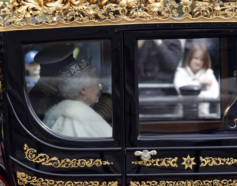 Britain's Queen Elizabeth II departs from Buckingham Palace on her way to the Houses of Parliament for the State Opening of Parliament, in London, Wednesday, May 9, 2012. From a gilded throne in the House of Lords the queen will read aloud the British Government's annual legislative package in traditionally opulent style.(AP Photo/Lefteris Pitarakis)