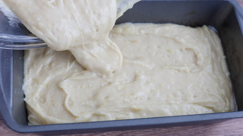 white batter pouring into loaf pan