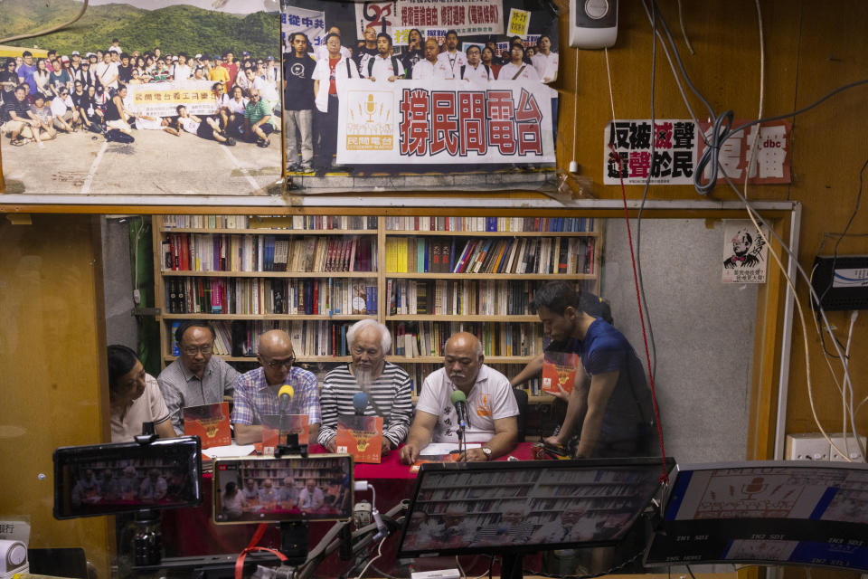 "The Bull" Tsang Kin-shing, right, founder of Hong Kong's pro-democracy Citizens' Radio station, along with guests, hold their last broadcast in Hong Kong, Friday, June 30, 2023. (AP Photo/Louise Delmotte)