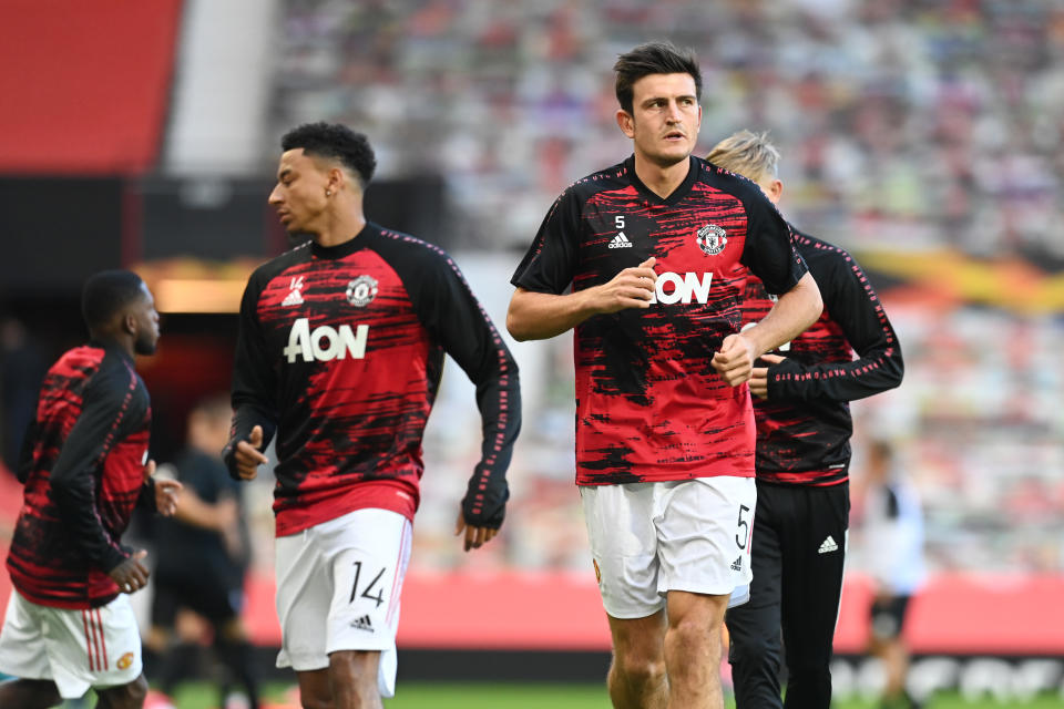 MANCHESTER, ENGLAND - AUGUST 05: Jesse Lingard and Harry Maguire of Manchester United warm up prior to during the UEFA Europa League round of 16 second leg match between Manchester United and LASK at Old Trafford on August 05, 2020 in Manchester, England. (Photo by Michael Regan/Getty Images)