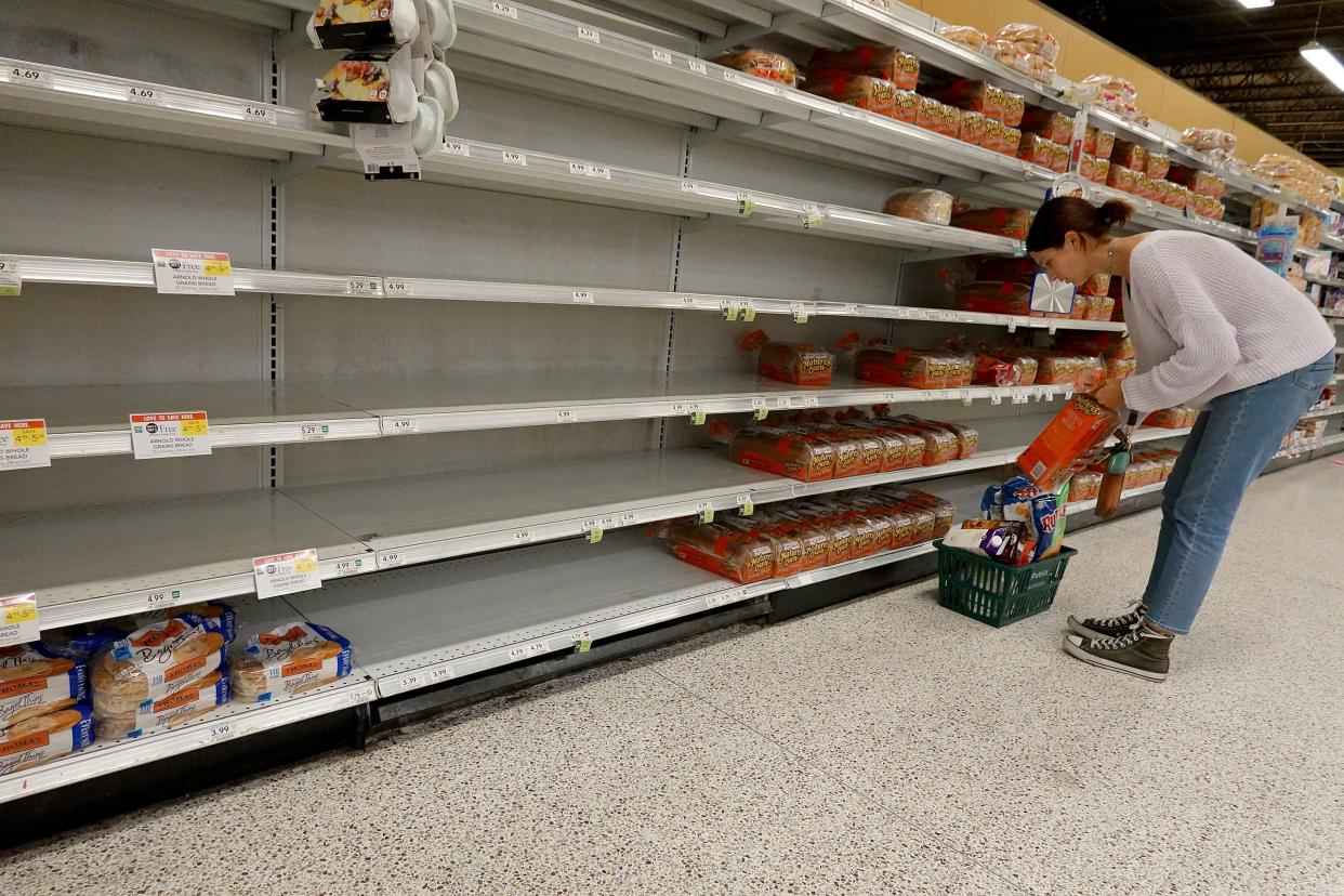 Shelves in the bread aisle stand nearly empty as residents prepare for Hurricane Ian on Sept. 26, 2022, in St Petersburg, Fla.