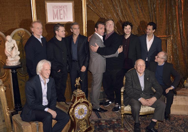 George Clooney (4thL) poses with writer Robert Edsel (L) and members of the cast of the film "The Monuments Men"(From L) Bill Murray, Matt Damon, Jean Dujardin, John Goodman, Dimitri Leonidas, Grant Heslov, and Bob Balaban, March 12, 2014