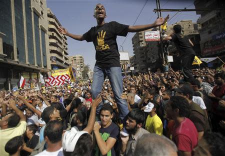 Members of the Muslim Brotherhood and supporters of ousted Egyptian President Mohamed Mursi shout slogans during a protest against the military near Rabaa al-Adaweya square in Cairo October 4, 2013. REUTERS/Amr Abdallah Dalsh