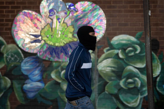 A pedestrian wears a balaclava ski mask to shield from the cold air in Philadelphia in 2021.