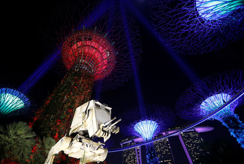 <p>A Star Wars AT-ST replica is displayed as Supertrees structures transform into “light sabers” during activities to mark the “May the 4th be with you” Star Wars Day at Gardens by the Bay in Singapore, May 4, 2017. (Photo: Edgar Su/Reuters) </p>