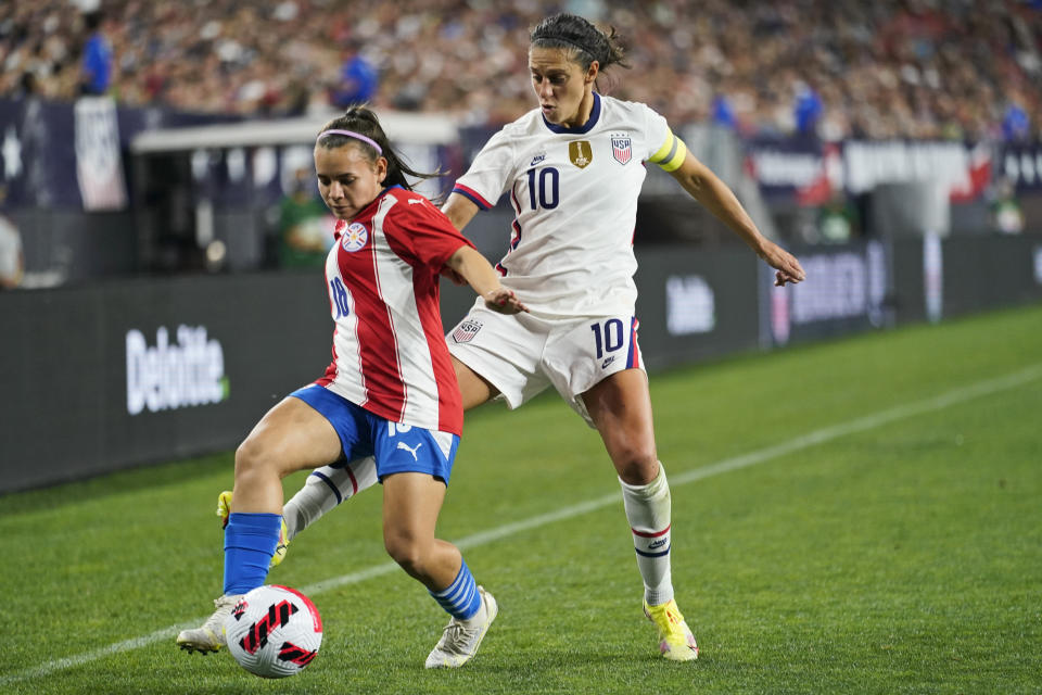 U.S. forward Carli Lloyd, right, and Paraguay forward Ramona Martinez (18) vie for the ball during the second half of an international friendly soccer match Thursday, Sept. 16, 2021, in Cleveland. The U.S. team won 9-0. (AP Photo/Tony Dejak)