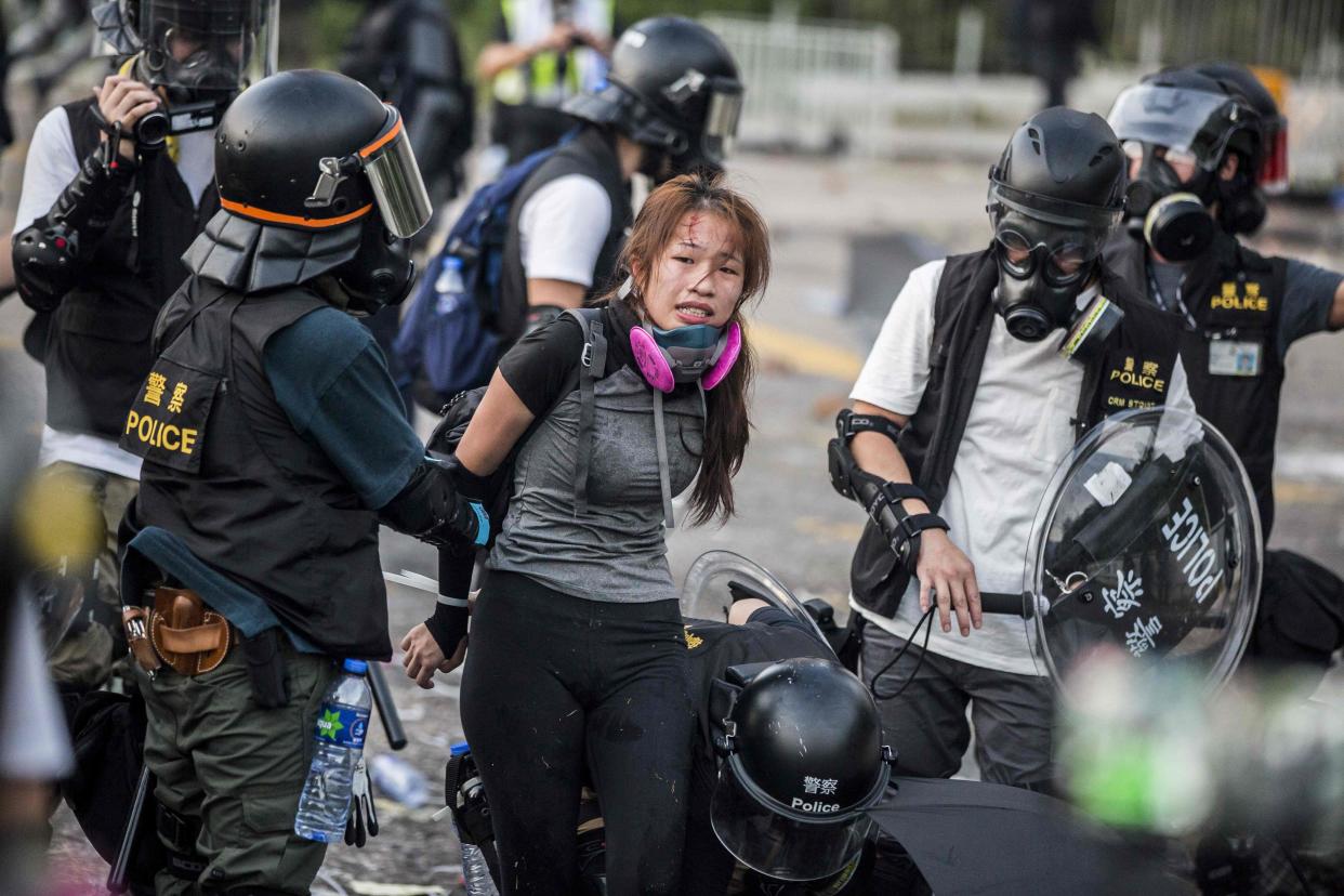 <p>Police detain demonstrators in the Sha Tin district of Hong Kong in 2019</p> (AFP/Getty Images)