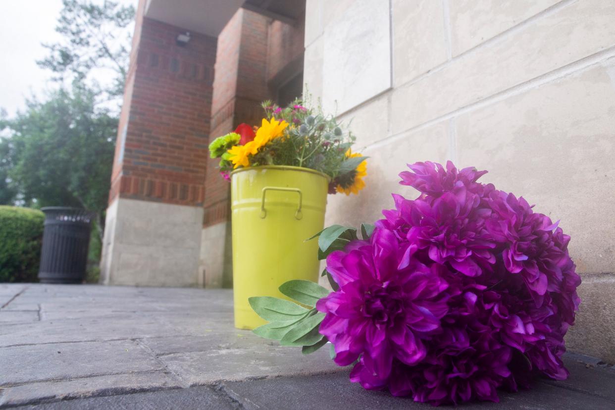 Flowers are seen by the entrance to Campbell Clinic two days after Dr. Benjamin Mauck was murdered in an examination room in the clinic in Collierville, Tenn., on Thursday, July 13, 2023. 