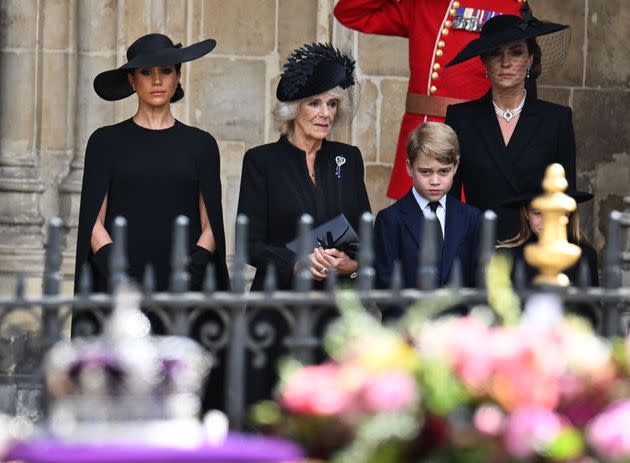 The Duchess of Sussex, the Queen Consort, Prince George of Wales and Catherine Princess of Wales look on at the coffin as they leave Westminster Abbey. (Photo: OLI SCARFF via Getty Images)