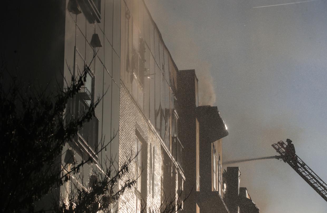 Louisville firefighters work to extinguish a fire at 310@NuLu apartment building in downtown Louisville early Monday morning. The apartment building has 173 units, according to a 2015 Courier Journal article. About 37 apartments were occupied in this building at the time, said Louisville Metro Fire Department Captain Donovan Sims. Feb. 19, 2024