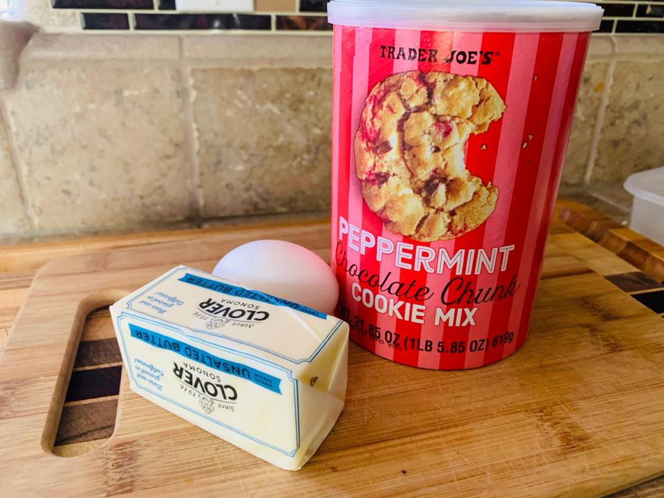 red package of trader joe's peppermint cookie mix on cutting board with egg and butter