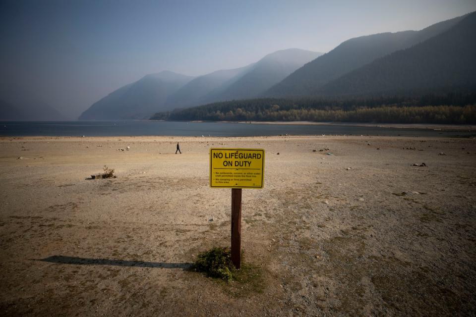 People walk along the shore of Alouette Lake which has receded due to drought like conditions in Golden Ears Park in Maple Ridge, British Columbia on Tuesday, October 18, 2022. 