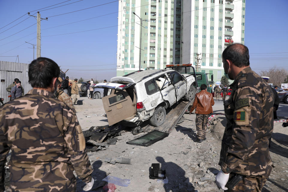 Afghan security personnel inspect the site of a bomb attack in Kabul, Afghanistan, Tuesday, Dec. 15, 2020. A bombing and a shooting attack on Tuesday in the Afghan capital of Kabul killed a few people, including a deputy provincial governor, officials said.(AP Photo/Rahmat Gul)