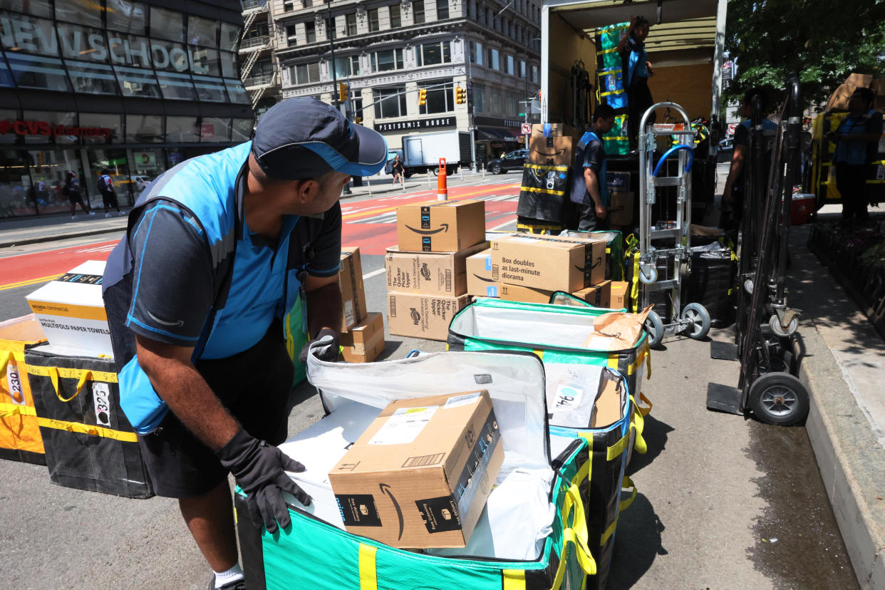 Amazon workers sort packages for delivery on E 14th Street on July 12, 2022 ahead of Prime Day in New York City. (Photo by Michael M. Santiago/Getty Images)