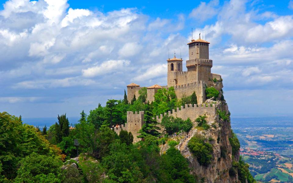 <p>If you’re visiting the world’s oldest, smallest republic, you’ll find it entirely engulfed in Italy. The Republic of San Marino is an enclave, as is Vatican City. After crossing the quirky border, you can score one of <a rel="nofollow noopener" href="http://www.travelandleisure.com/travel-tips/offbeat/coolest-passport-stamps/7" target="_blank" data-ylk="slk:the world’s coolest passport stamps;elm:context_link;itc:0;sec:content-canvas" class="link ">the world’s coolest passport stamps</a>.</p>