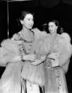 <p>Then-Princess Elizabeth and Princess Margaret went glamorous for a royal variety performance in London. The sisters each wore an elaborate ball gown with fur wraps.</p>