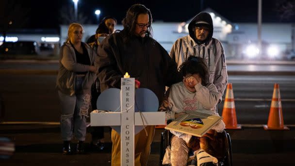 PHOTO: Richard Fierro consoles his daughter, Kassandra, as she signs a plaque to her slain boyfriend at a memorial outside of Club Q, Nov. 22, 2022 in Colorado Springs, Colorado.  (Chet Strange/Getty Images)