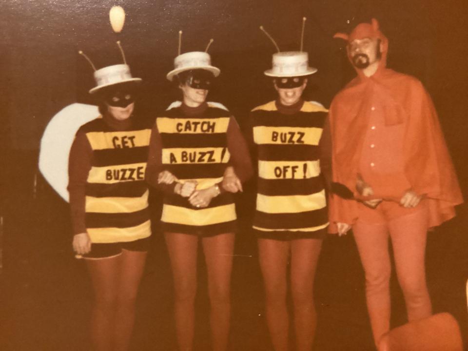 Mary Kohl in the "Buzz Off!" costume smiles with her sister and friends in costumes for Halloween, as seen in 1981.