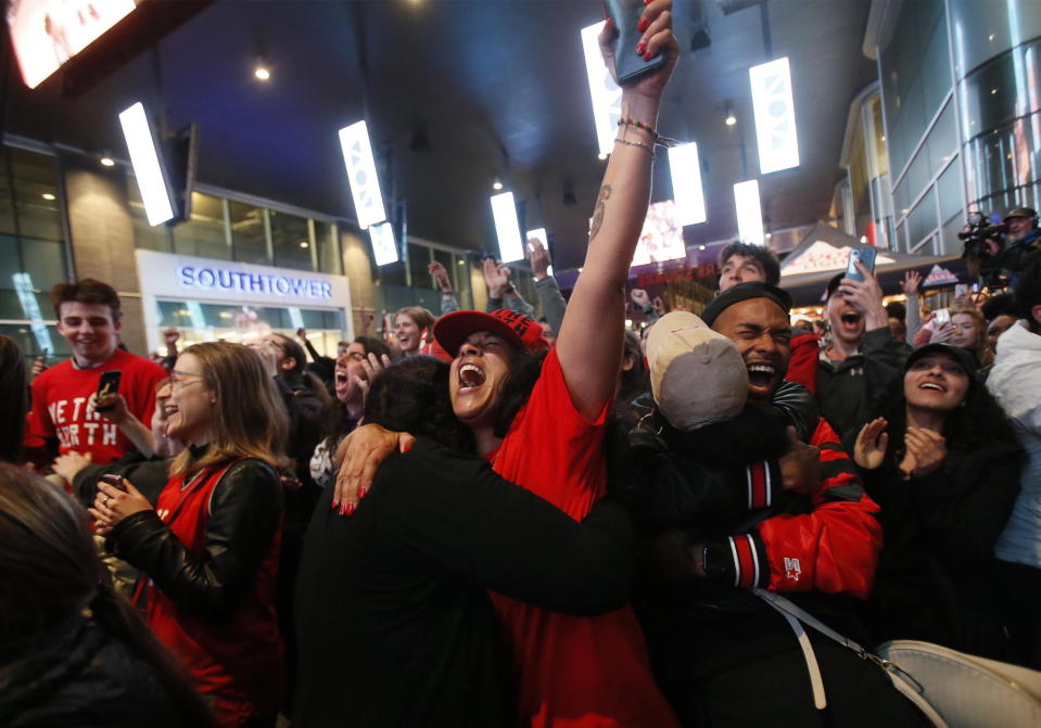 Toronto Raptors fans celebrate at a public telecast early Friday, June 14, 2019, in Halifax, Nova Scoatia, following the Raptors' 114-110 win over the Golden State Warriors in Oakland, Calif., in Game 6 of basketball's NBA Finals. (Tim Krochak/The Canadian Press via AP)